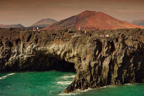 Tourists on the rocky coast of Los Hervideros
