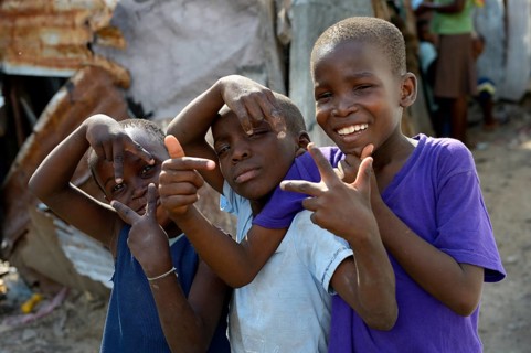 Three boys posing with wild gestures