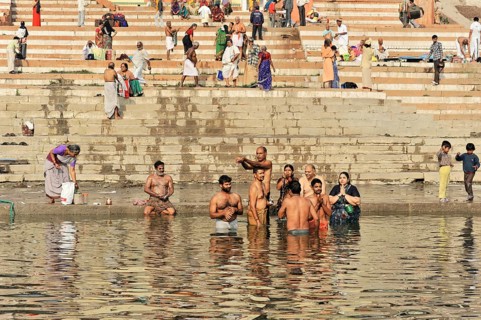Devotees in ritual ablutions on the banks of the Ganges