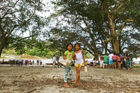 Girls selling sugar cane on the jungle beach of Misahualli