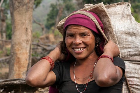 Nepalese farmwoman carrying a full bag