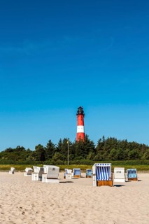 Beach chairs on the beach in front of the lighthouse