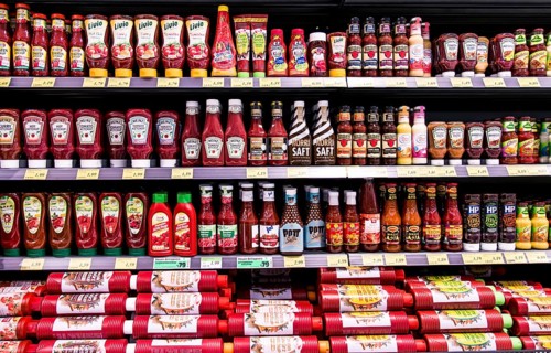 Shelf with various ketchups and sauces