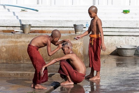 Novice monks during a head shave in the Shwe Yaunghwe Kyaung Monastery