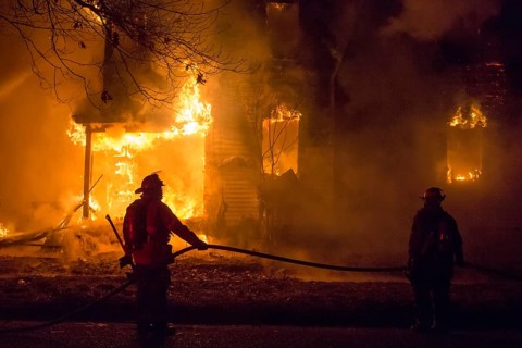Firefighters battle a fire which destroyed a vacant home in Detroit's Morningside neighborhood