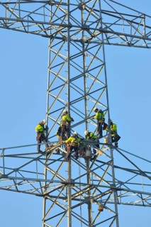 Overhead linemen working on a pylon