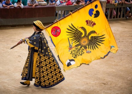 Man carrying a flag from the Eagle or Aquila contrade