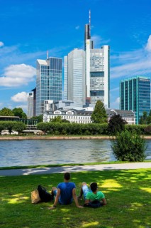 Young people at the Main River overlooking the Commerzbank