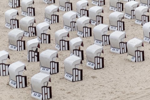 Roofed wicker beach chairs on the beach