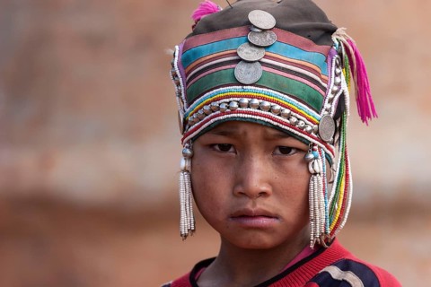 Girl of the Akha ethnic group with traditional headdress