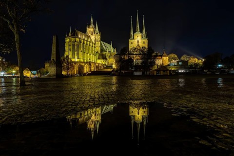 Erfurt Cathedral and Church of St. Severus at night with reflection in a puddle