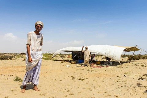 Rashaida man standing in front of his tent in the desert around Massaua