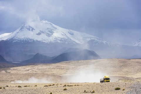 Guallatiri volcano with a a truck en route to the Salar de Surire