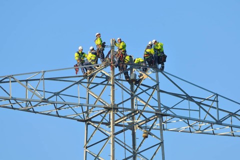 Overhead linemen working on a pylon