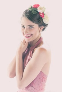 Beauty portrait of a smiling young woman with flowers in her hair
