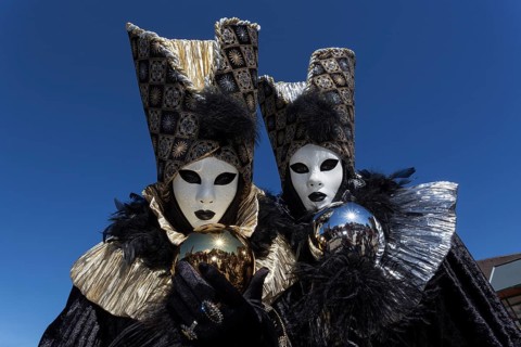 Venetian Carnival masks and costumes at the Venetian Fair on the historic market square