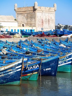 Old blue fishing boats in the port of Essaouira