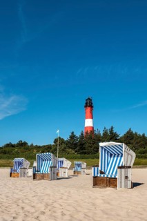 Beach chairs on the beach in front of the lighthouse