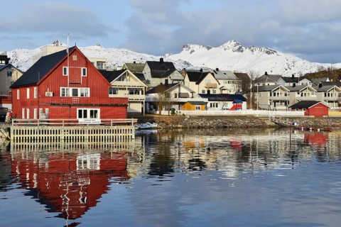 Red house with a private waterfront and several houses in the village