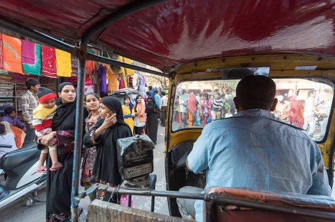 Auto-rickshaw rides through busy street