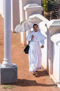 Smiling nun with parasol