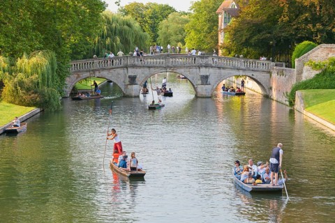 Punting on the river Cam with Clare Bridge in the distance