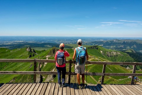 Hiker looking at the mountains of Massif of Sancy