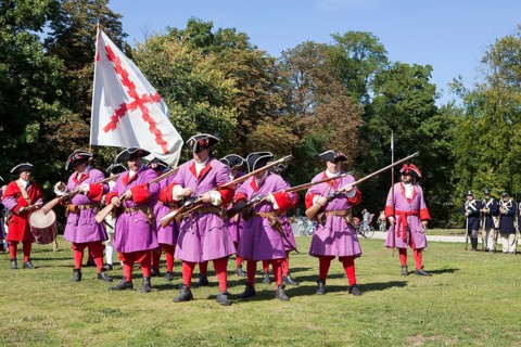 Soldiers with muzzle-loading rifles shooting during live role-playing or ReenLarpment