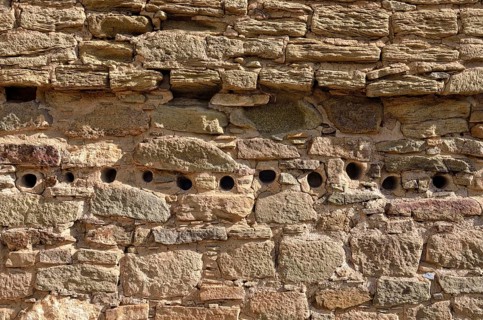 Wall detail with openings for round support beams