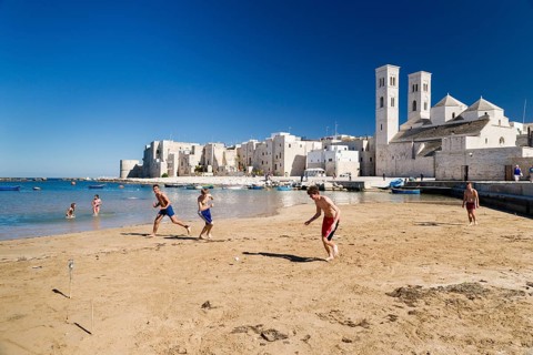 Teenagers playing football onthe beach