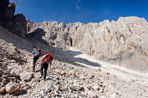 Hikers climbing to the summit of Plattkofel mountain