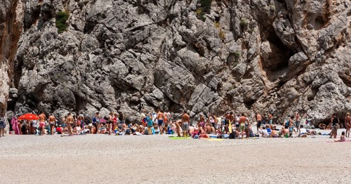 Tourists sunbathing in Torrent de Pareis Gorge