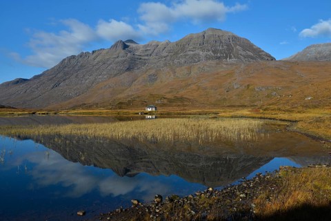 Mountains reflected in a lake in the Highlands in front of Liathach hill