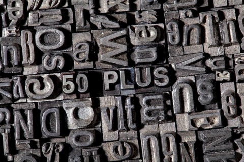 Old lead letters forming the term '50 PLUS'