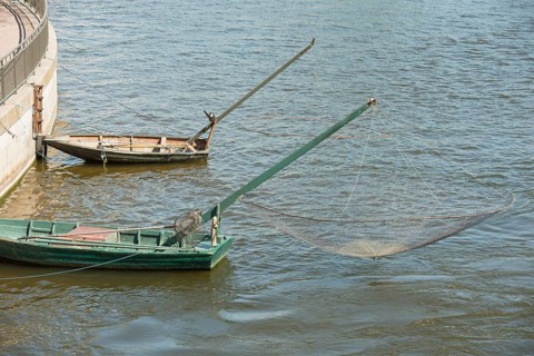 Two boats with old-fashioned nets in the center of Stockholm