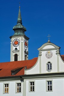 Church steeple with a tower clock and a sundial