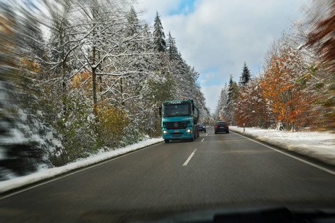 A country road through a snowy forest near Feldkirchen-Westerham