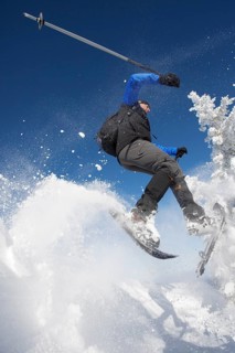 Snowshoe hiker jumping