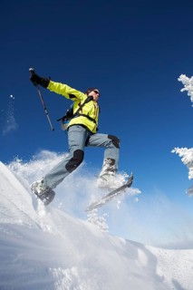 Snowshoe hiker jumping
