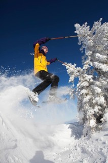 Snowshoe hiker jumping