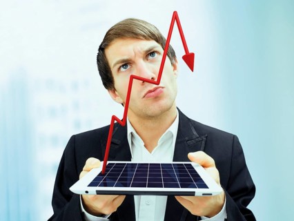 Businessman with a serious face holding an iPad with a plunging stock chart