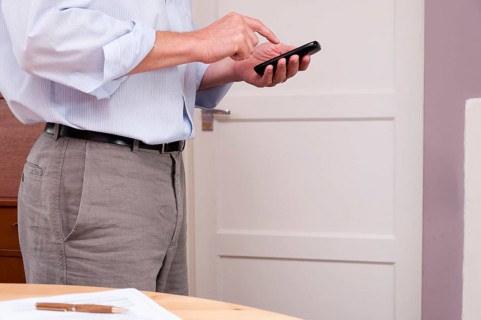 Businessman working at home using a smartphone