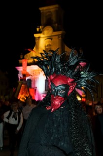 Person with a demonic devil's mask at night