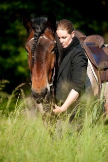 Woman with a Belgian Draft Horse in a meadow