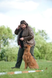 Woman longeing a mixed-breed dog