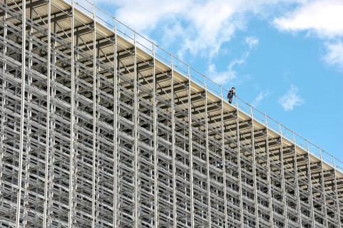 Worker on the roof of a high bay warehouse during construction