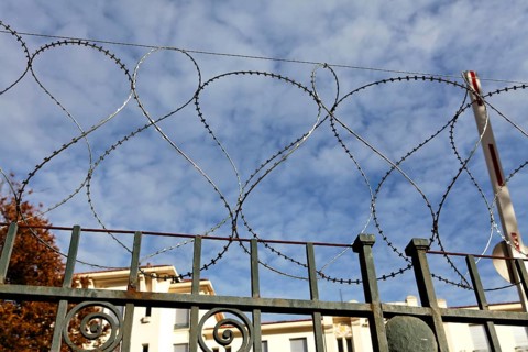 Barbed wire around abandoned building
