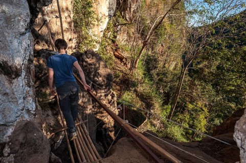 Woman walking on a bamboo bridge