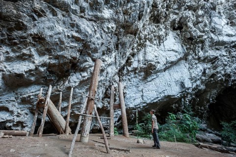 Woman admiring thousands of years old teak coffins