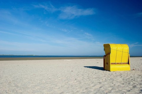 Yellow roofed wicker beach chairs on the beach near Utersum